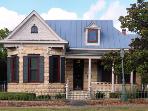 The Beseler House, a limestone house with a blue metal roof in Boerne, Texas