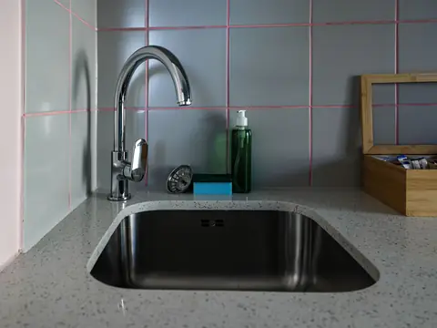A chrome kitchen faucet over a stainless steel sink